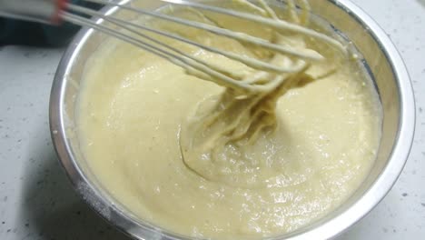 mix the flour and other ingredients until well blended manually. it is the early stage of the baking bread and cakes process. this will take some time to get a good mix.
