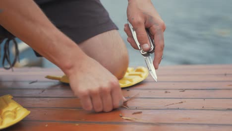 cutting out damaged timber from cabin roof planking