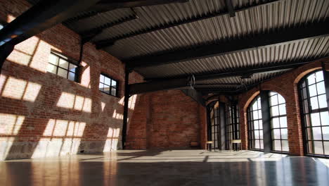 empty industrial loft space with exposed brick walls and natural light