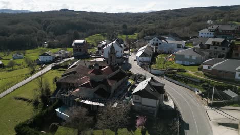 aerial pullback overview of small town and church in san xoan de rio