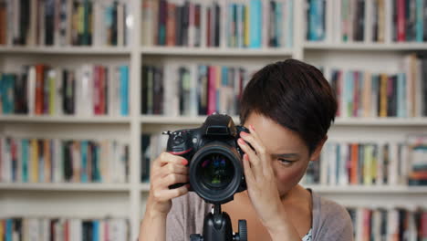 Girl-friends-having-fun-hanging-out-at-home-using-instant-camera-taking-photos