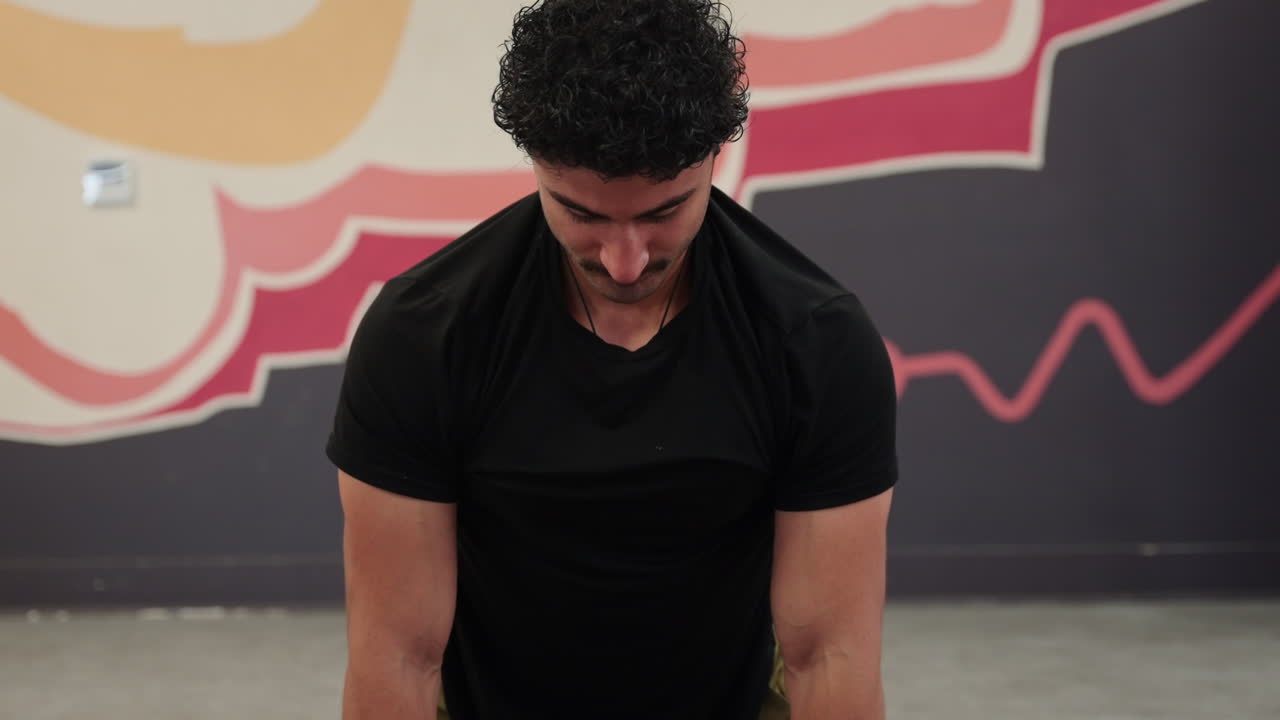 Man stretching on the workout mat, front view