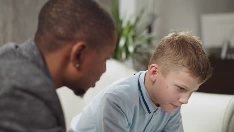 Black man tutor conducts private English lesson to schoolboy