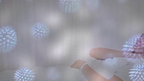 animation of virus cells over sick caucasisan woman lying in bed