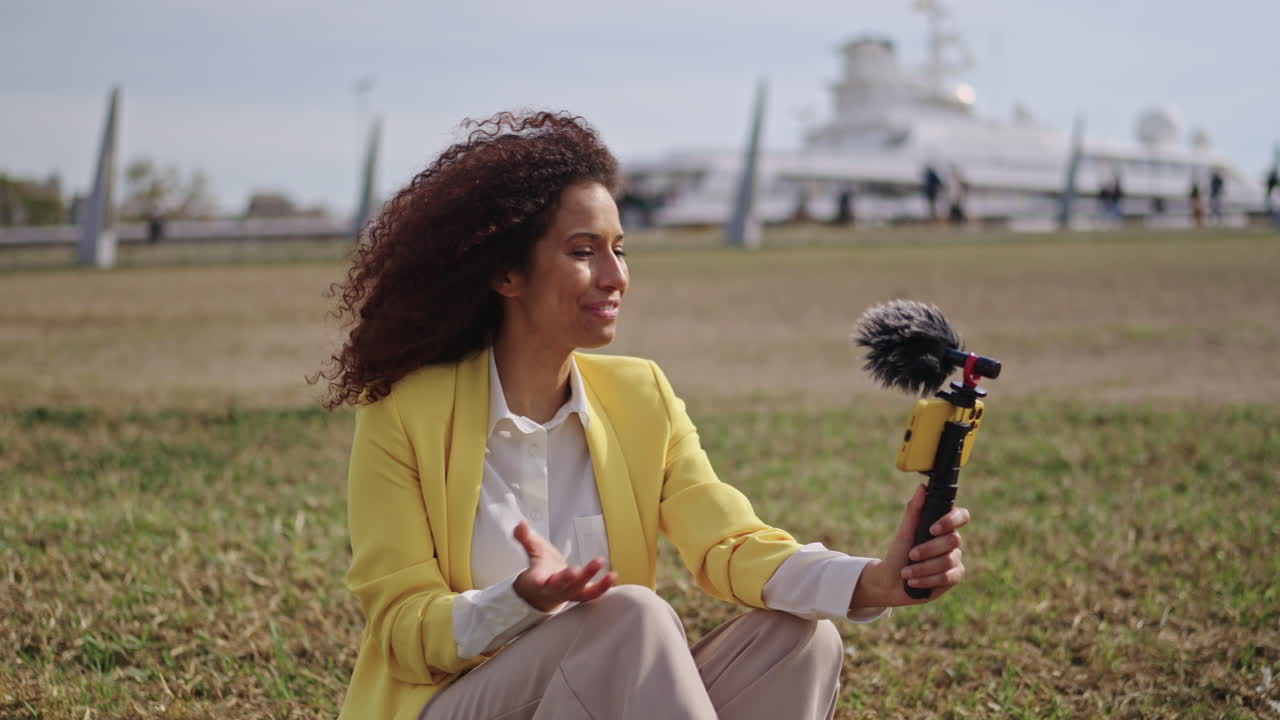 Woman vlogging outdoors with microphone
