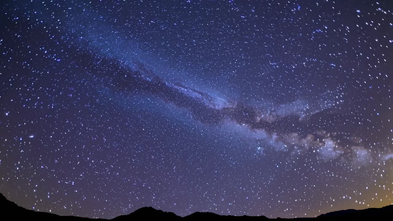 A mesmerizing night sky with the Milky Way captured in a wide-angle shot, perfect for a time-lapse