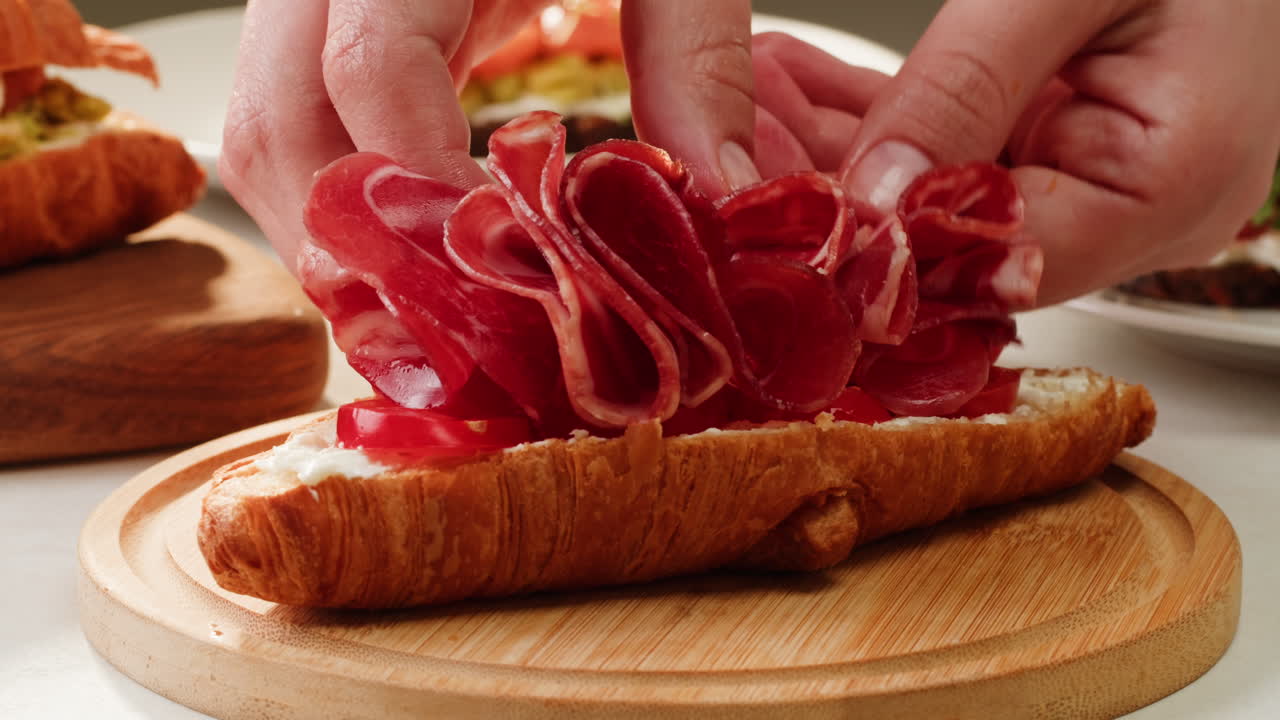 Preparing Croissant Sandwiches with Smoked Meat and Cheese