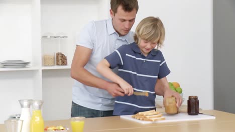 Panorama-of-dad-and-son-preparing-a-meal-in-the-kitchen