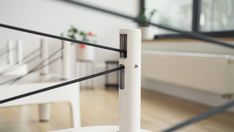 Straps On Risers Of Pilates Reformer Machine. - closeup shot