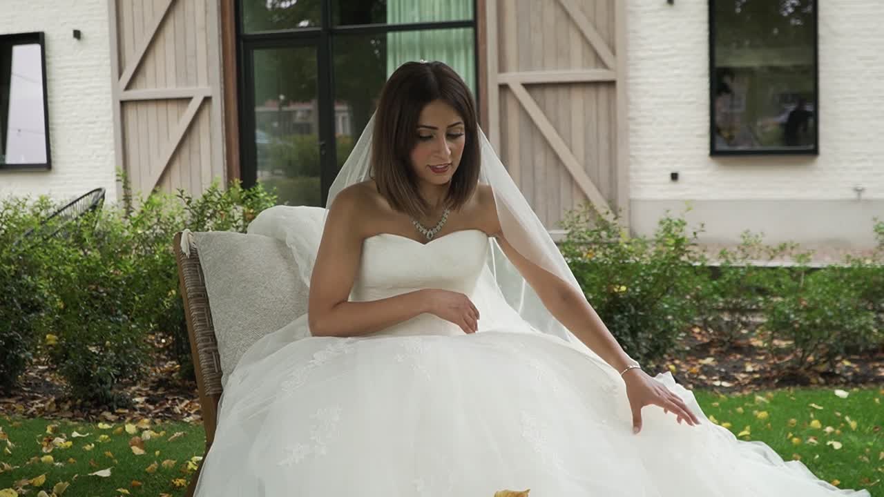 Bride putting her dress correctly to get ready to take some pictures