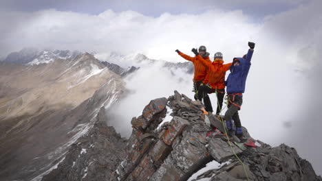 climbers celebrating on a mountain peak
