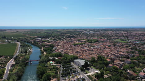 aerial back traveling over serignan city france mediterranean sea in background