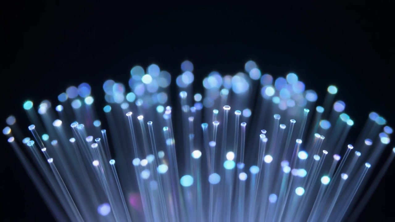 Glowing Fiber Optic Cables Against Dark Background