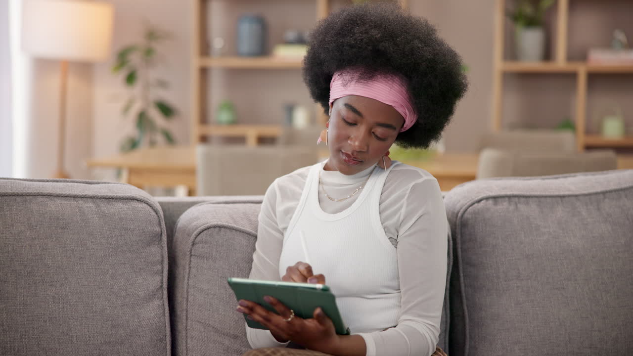 Woman Using Tablet On Couch