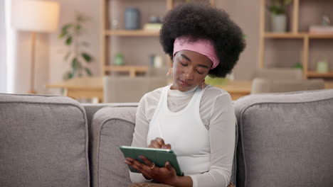 woman using tablet on couch