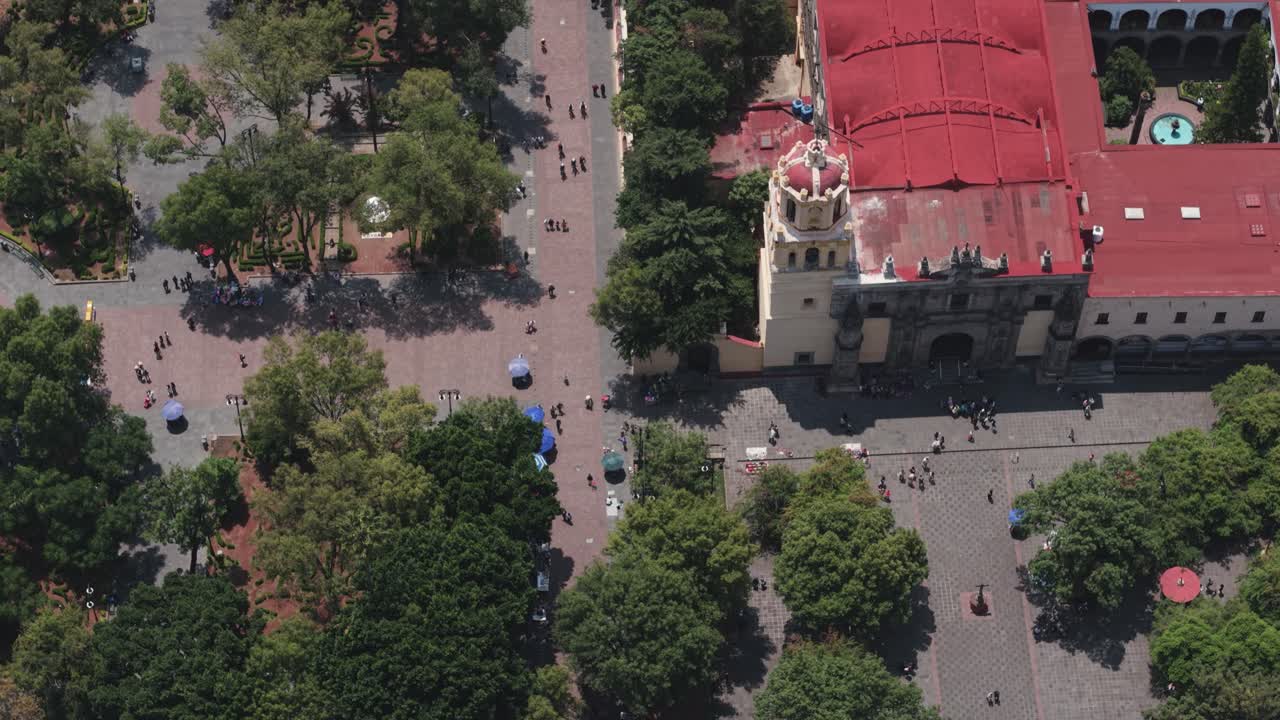 Drone shot of the kiosk and church in Coyoacan's main park, Mexico City