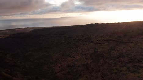 Aerial-low-tilting-up-shot-of-Ni'ihau,-the-Forbidden-Island-of-Hawai'i-off-the-coast-of-Kaua'i-at-sunset