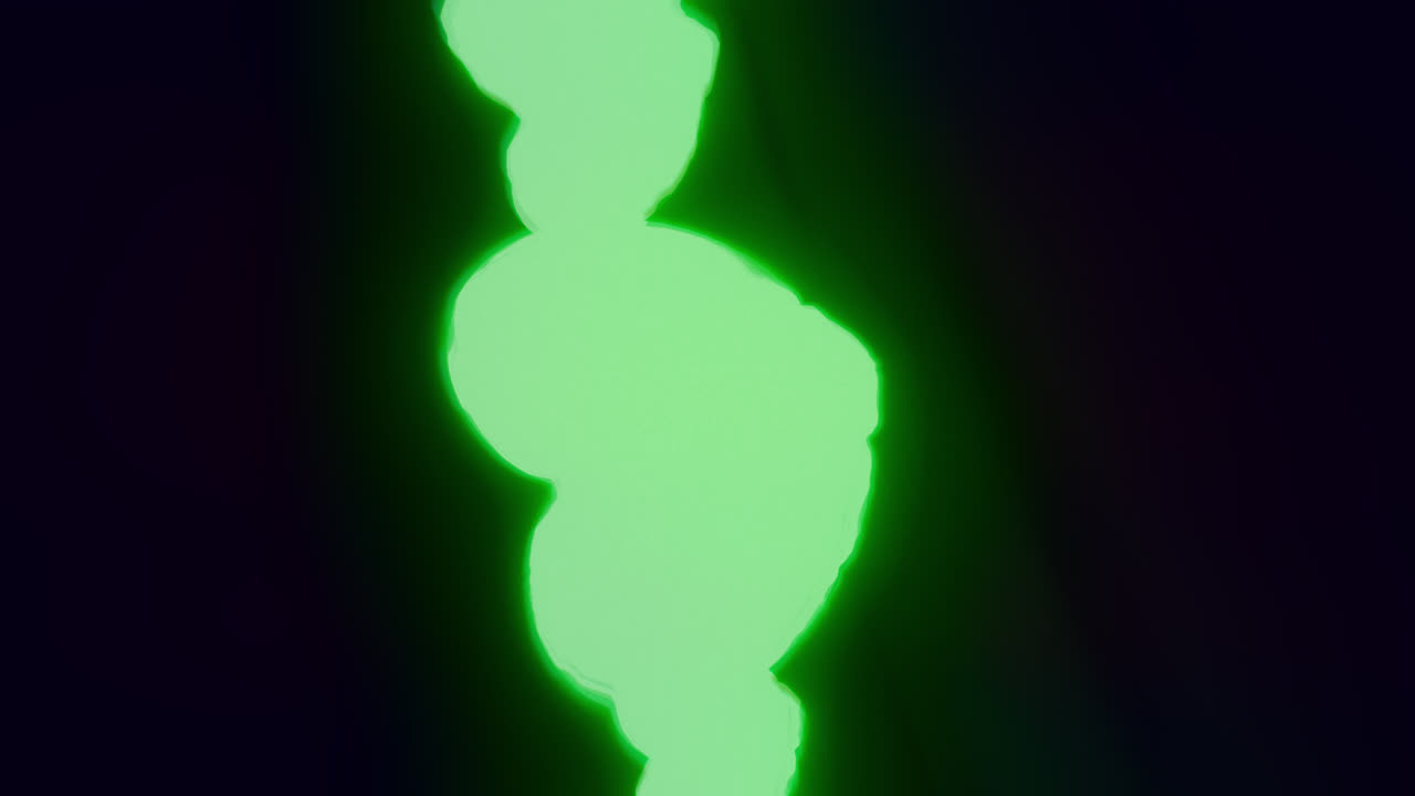 Green energy heart shapes on a dark background