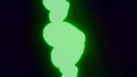 green energy heart shapes on a dark background