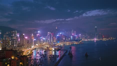 elevated view overlooking victoria harbour skyline at dusk, hong kong island, hk