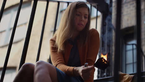 beautiful sad woman burning photograph of her ex-boyfriend lover