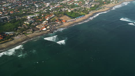 panorama of overcrowded batu bolong beach in canggu resort, bali, indonesia, aerial