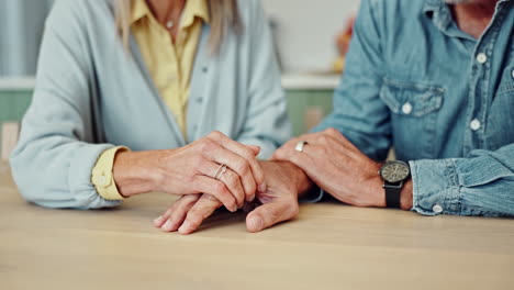 close-up of an elderly couple holding hands