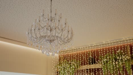 elegant crystal chandelier and fairy lights wedding decoration