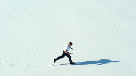 aerial view of man running in the snow