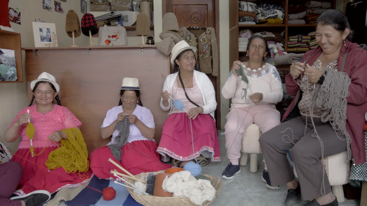 group of indigenous women working with wool thread and enjoying their time together