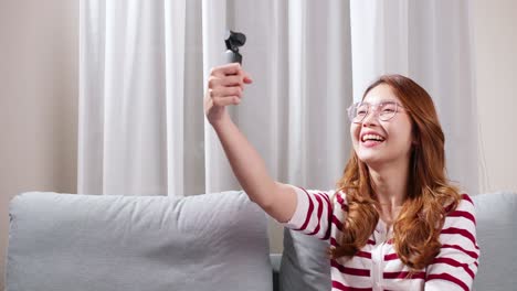 girl doing vlog in her house holding camera in hand