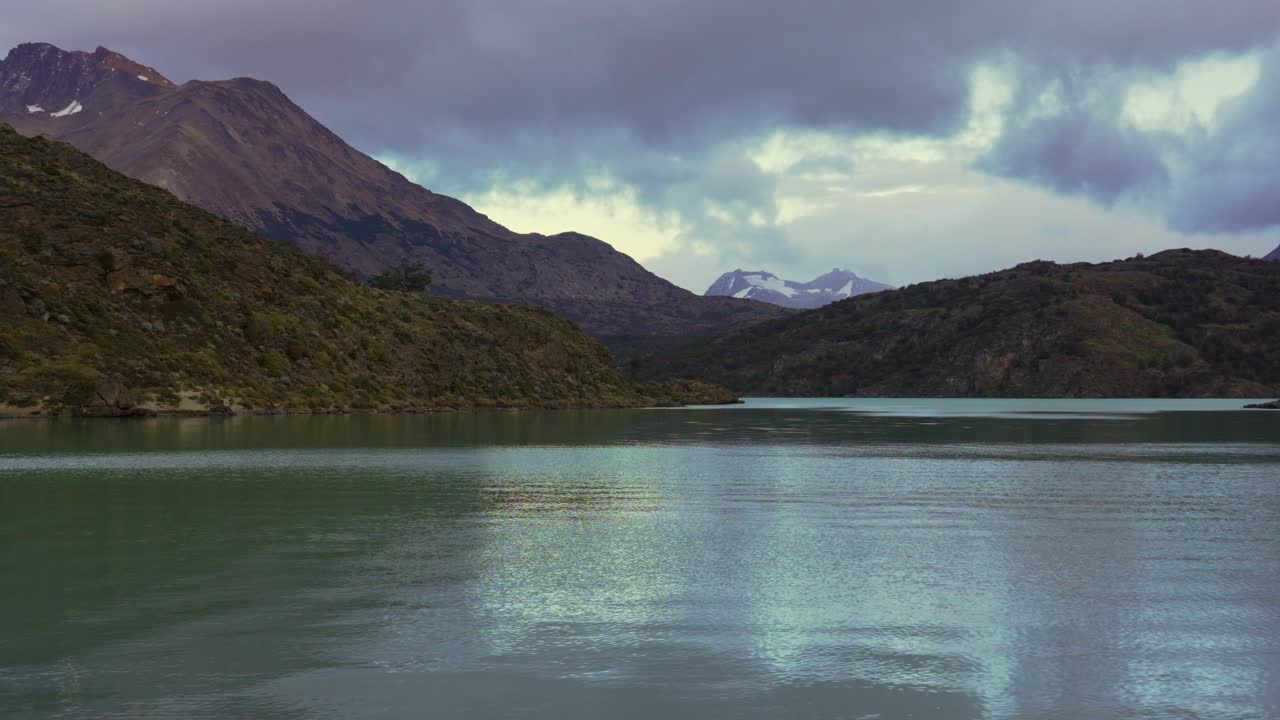 Static shot of Lake Belgrano with turquoise waters surrounded by rugged mountains and distant snow-capped peaks in Perito Moreno National Park, Southern Patagonia, Argentina