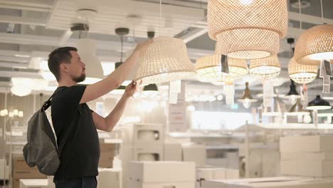 man shopping for ceiling lights in a home improvement store