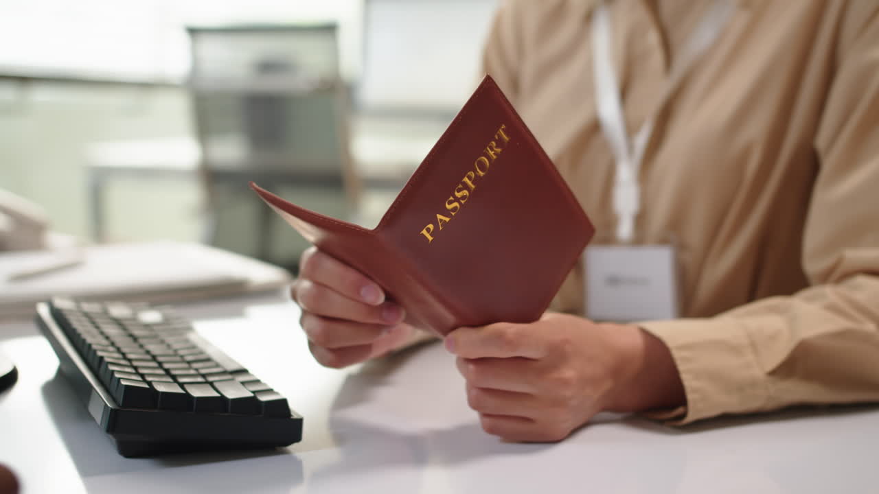 Consultant Entering Data of Clients Passport on Computer