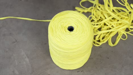 Ball-of-yellow-thread,-video,-panoramic-plane,-high-angle-shot