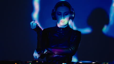 woman dj performing on stage in a nightclub