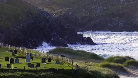 golden hour footage of the cemetary, waves and the headland around dalmore beach near carloway