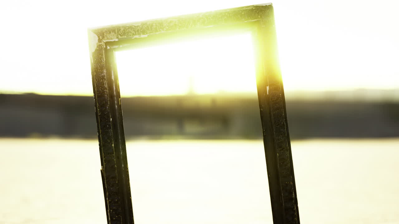 Sunlight streaming through a frame in a tranquil landscape at sunset