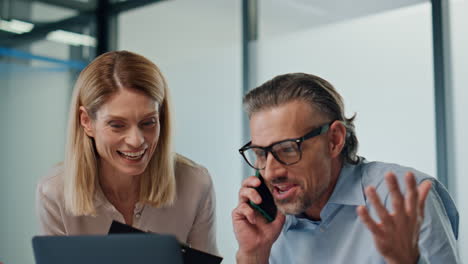 Excited-office-workers-rejoicing-indoor-closeup.-Partners-celebrating-together