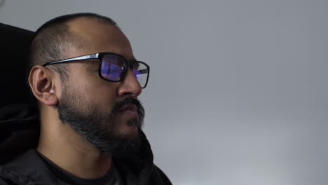 ethnic minority male with computer screens reflected in eye glasses