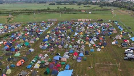 aerial view of multi-colored tents pitched in a field at a music festival
