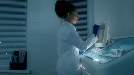 scientist working on medical equipment in a laboratory at night