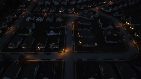 las luces iluminan las casas en el vecindario americano por la noche.