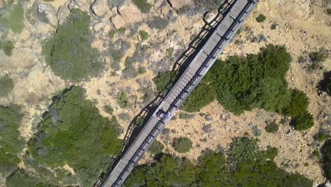 aerial overhead shot of a wooden walkway in a cape of the coast of cadiz