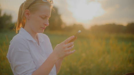woman browsing social media at sunset