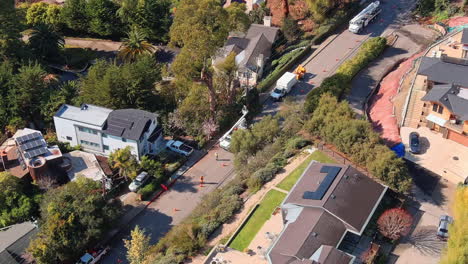 cinematic topdown view of power line maintenance in inviting suburb