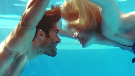 happy couple kissing underwater