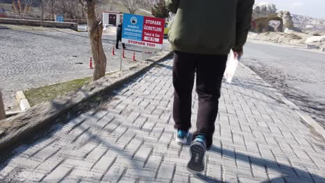 person walking on a stone path in cappadocia, turkey