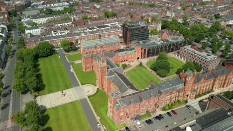 forward travelling adjacent aerial video of queen's university belfast, in northern ireland, uk on a bright and sunny day. produced at 4k resolution, 60fps and with rec709 color.