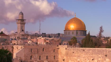 the dome of the rock towers over the old city of jerusalem and the wailing wall 1